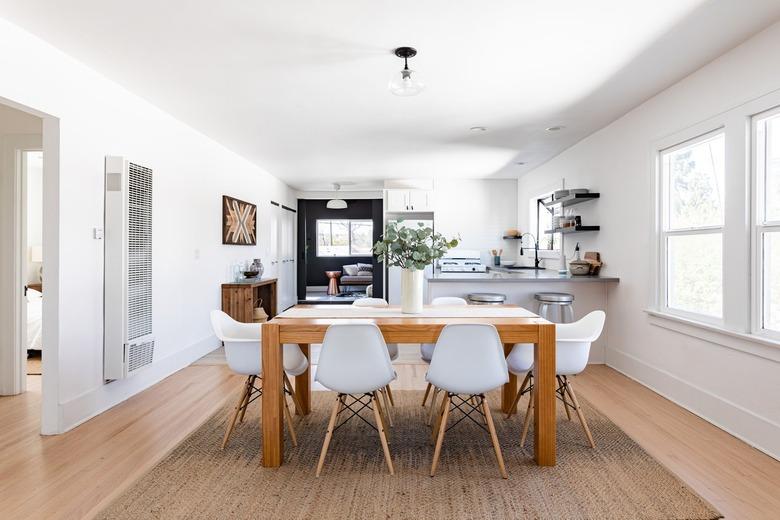 dining room with wood table and white chairs