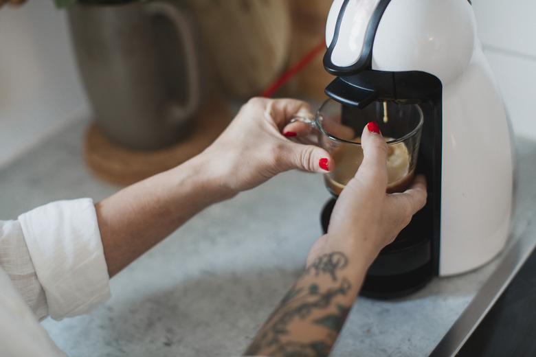 Young woman making coffee