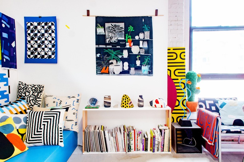 white studio living room with statement artwork and decor featuring bright colors and wiggly lines