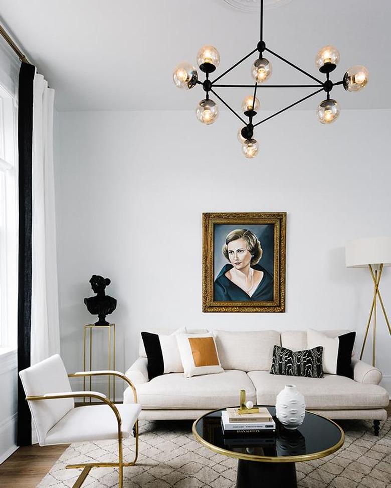 Living room lighting idea with chandelier and vintage painting