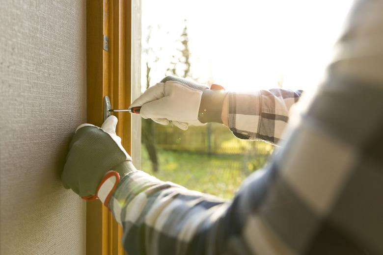 Handyman fixing the window with screwdriver