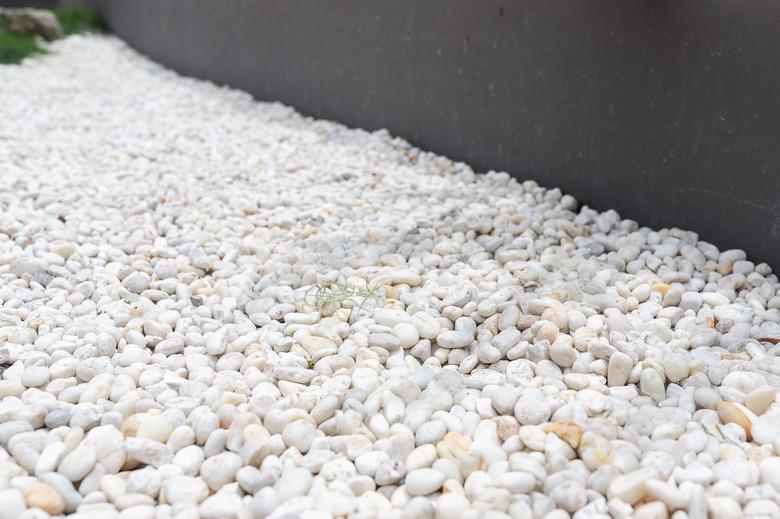 focus at modern white pebbles decoration in garden.