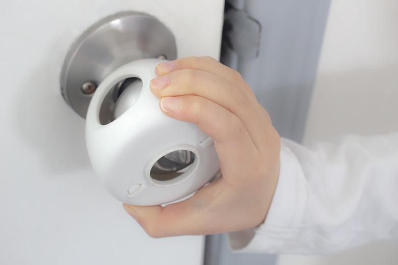 Child Proof Door Knob Covers over doorknob with a kid