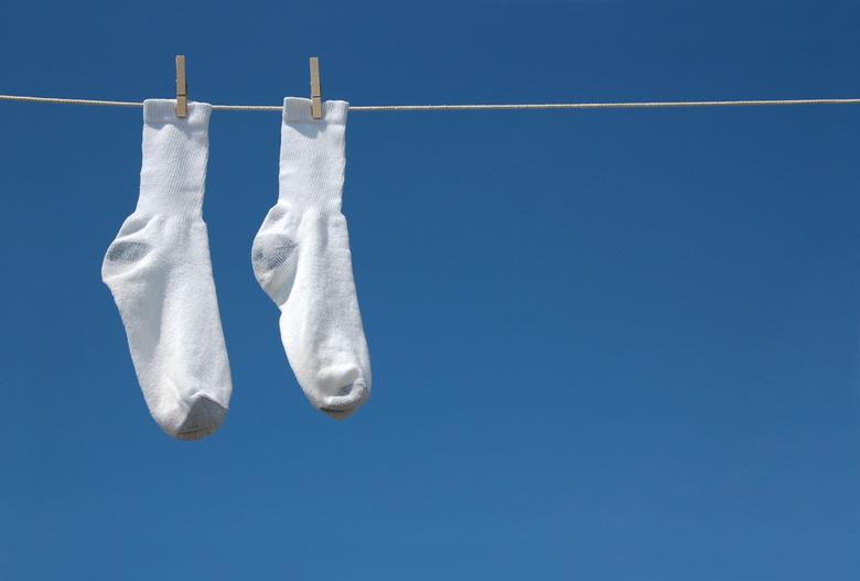 White socks hanging on clothesline.