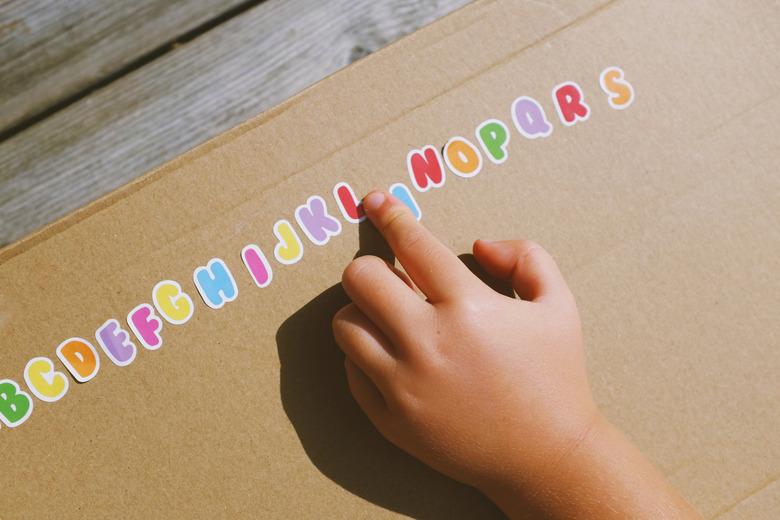 Child's hand and alphabet stickers