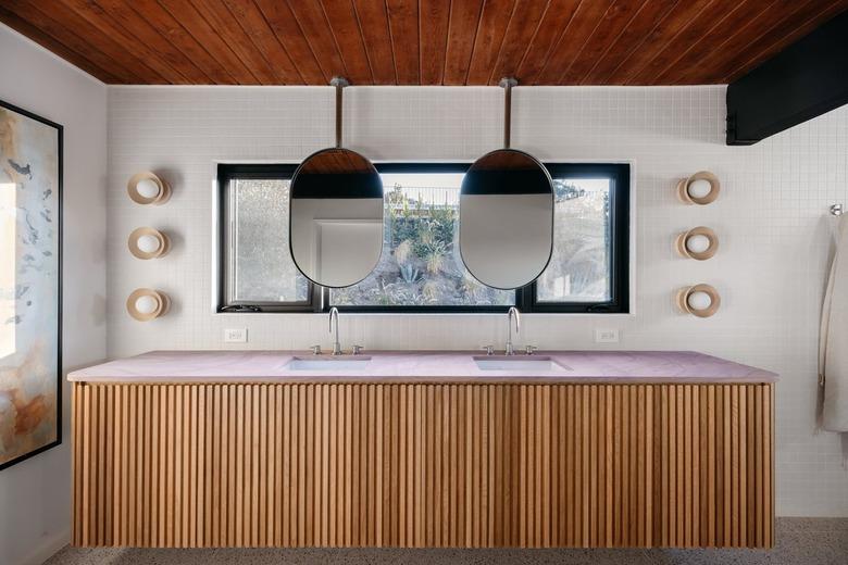 midcentury modern bathroom with fluted furniture and sconce lights on either side