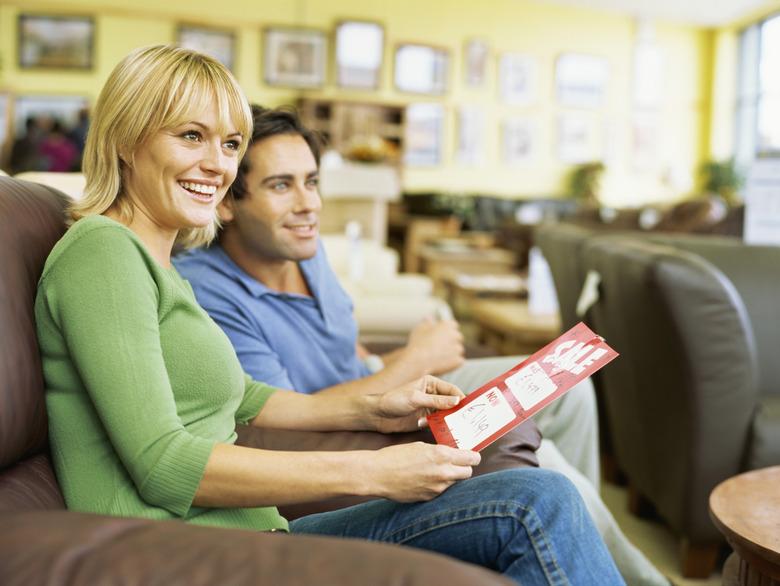 side profile of a young couple sitting in a furniture store