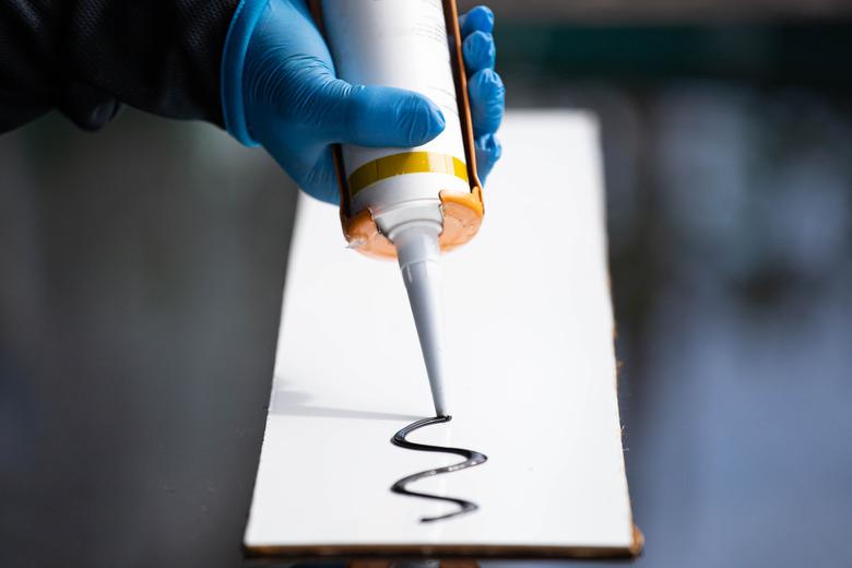 Closeup of silicone glue and glue gun.