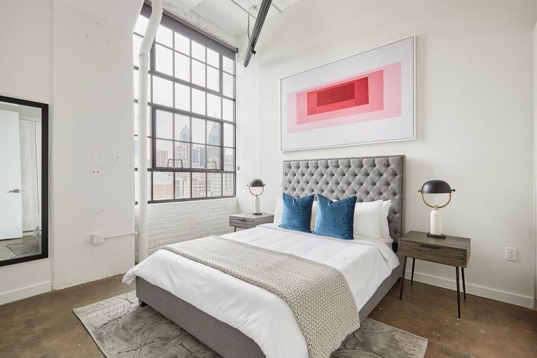 A bedroom with concrete flooring