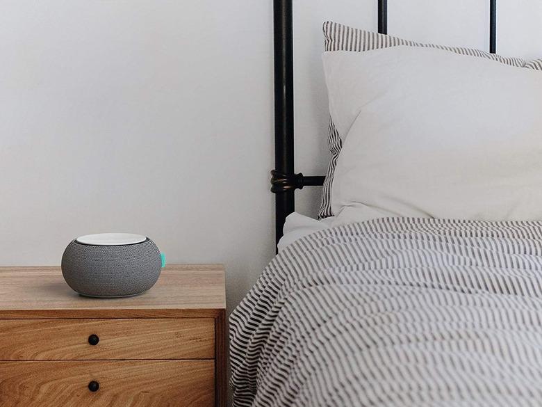 White noise machine next to made bed