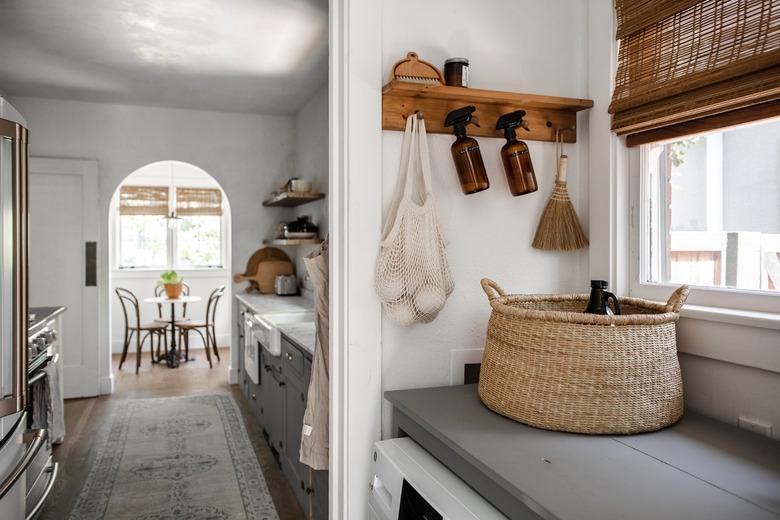 laundry room with cleaning items on wall