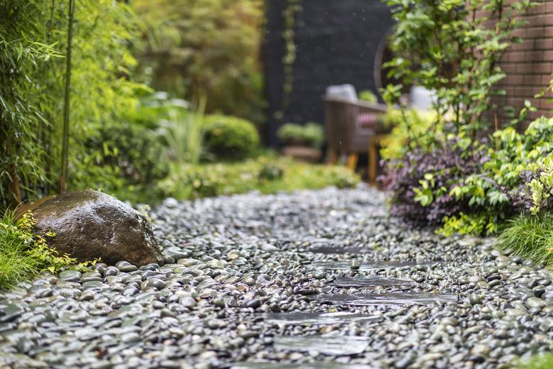 Decorative sprinkling of flowerbed paths with pebbles