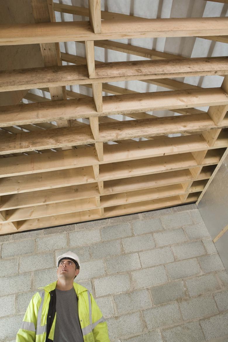 Construction worker looking at rafters