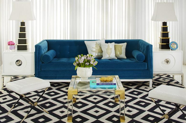 art deco living room with blue couch and patterned rug