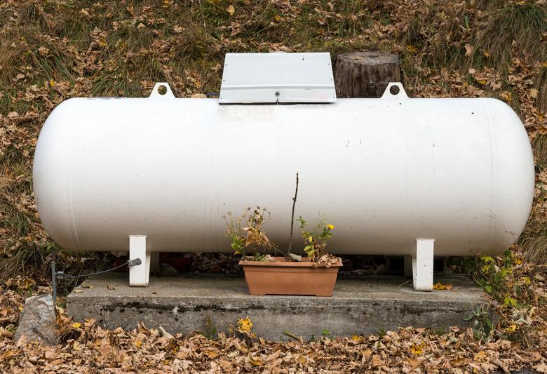 a propane gas tank in a garden.