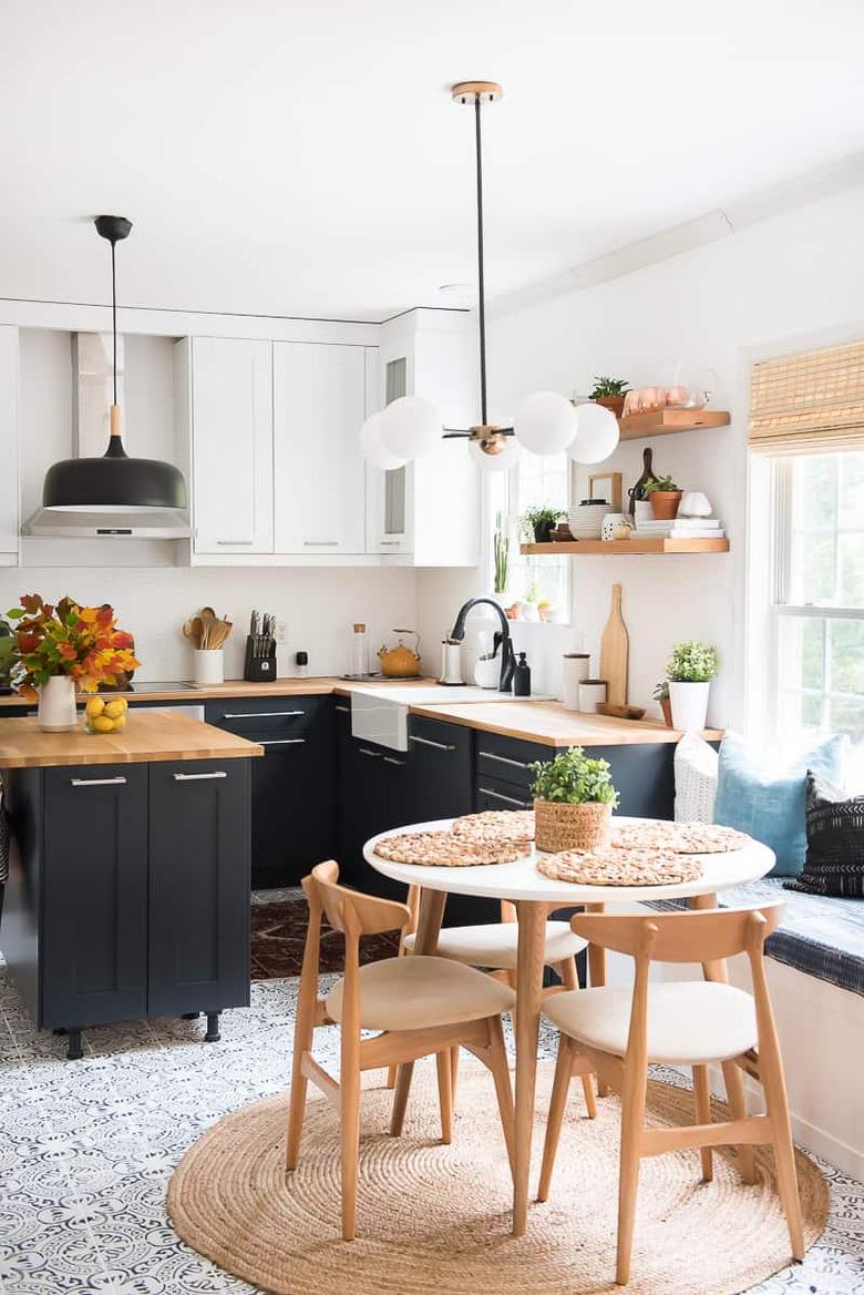 black eat-in kitchen with modern wood table and chairs