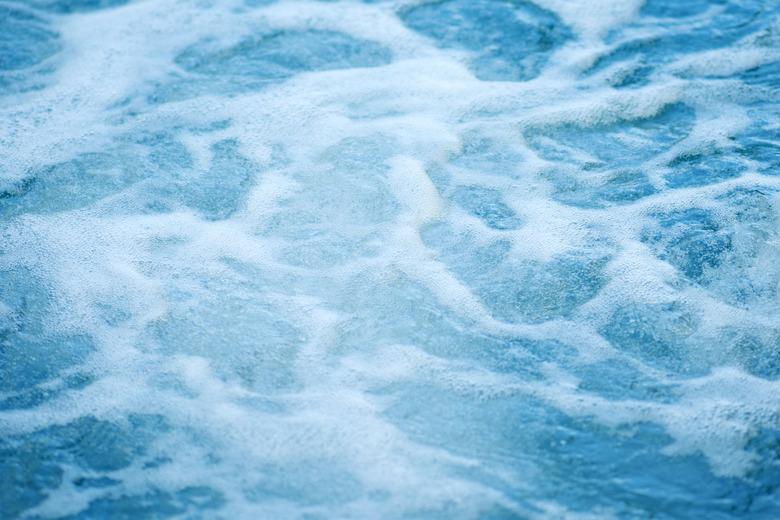 Blue clear fresh Water in jacuzzi. Spa massage background.