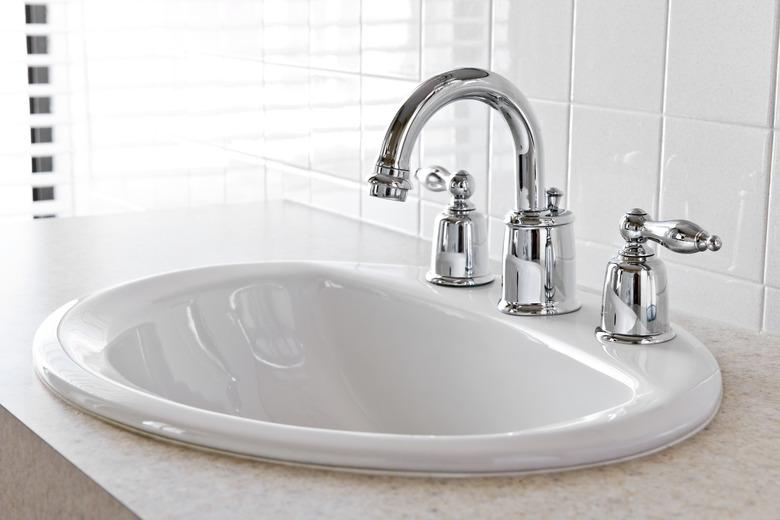 Closeup of bathroom vanity with white sink.