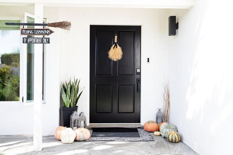 black exterior door with fall decor