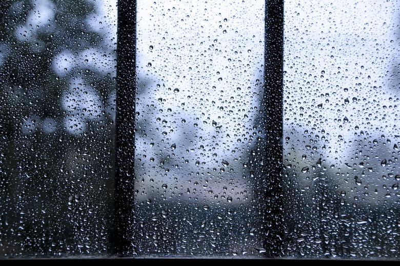 Raindrops on window pane on a cold day of winter