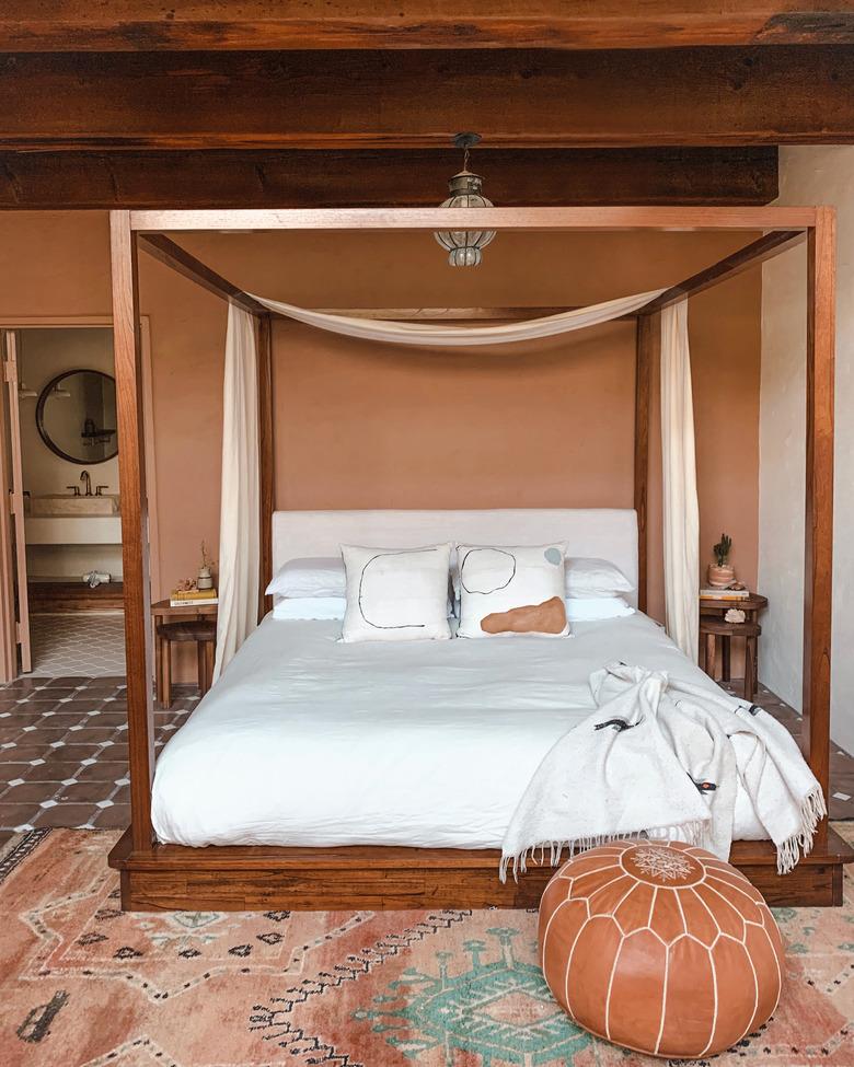 terracotta and clay desert house color palette in bedroom with canopy bed