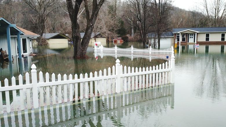 Fence In Water Amidst Houses During Flood