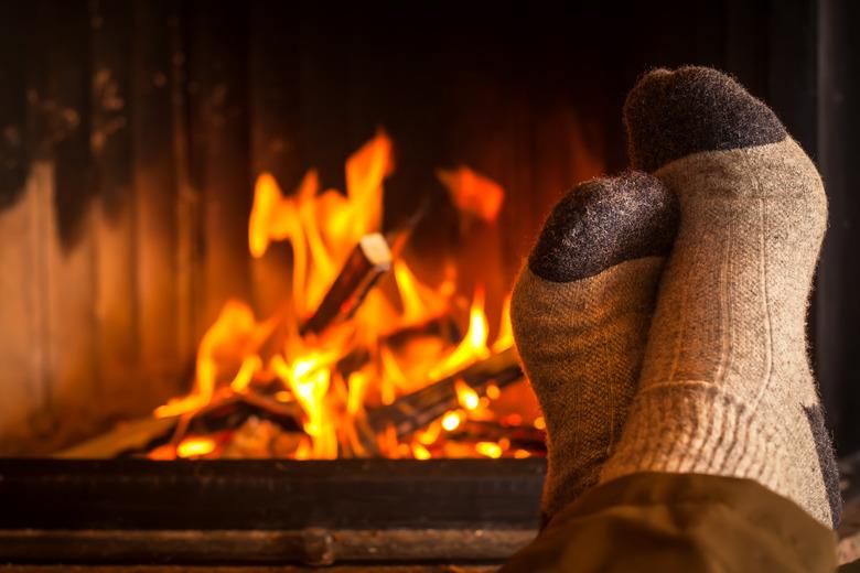 warming feet at fireplace