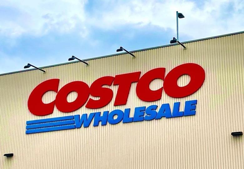 Image of costco logo on a storefront in front of a blue sky