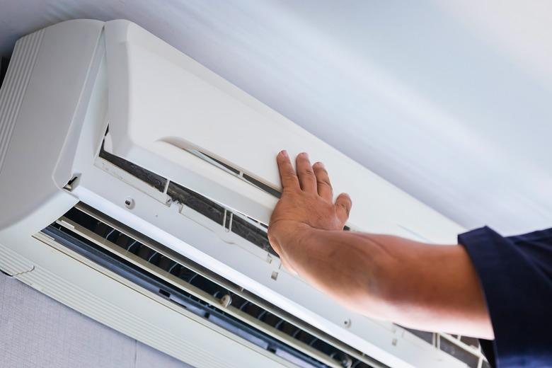 Air Conditioning Repair, Repairman fixing air conditioning system, Male technician service for repair and maintenance of air conditioners.