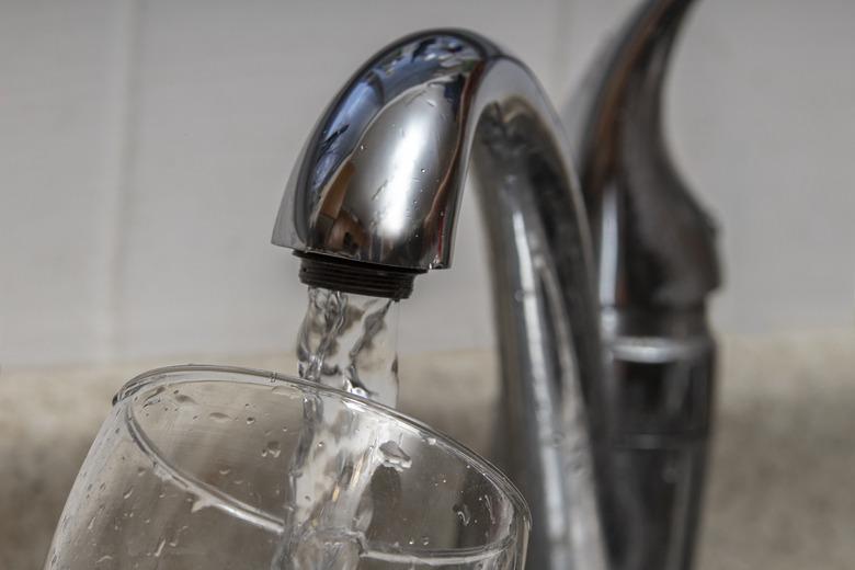 Glass at water tap and filling water with lead contamination