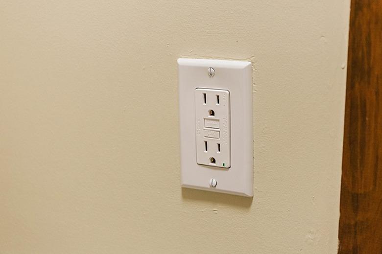 Wall GFCI outlet on a painted beige wall