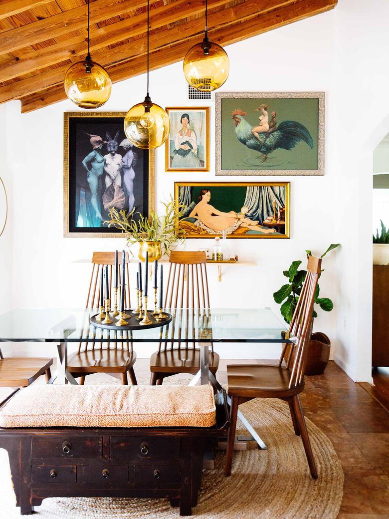 vintage midcentury modern furniture in dining room with glass table and wood chairs