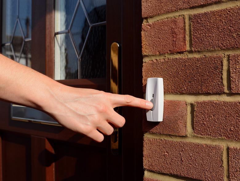 Ringing a doorbell.