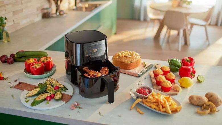 philips essential airfryer on countertop with food