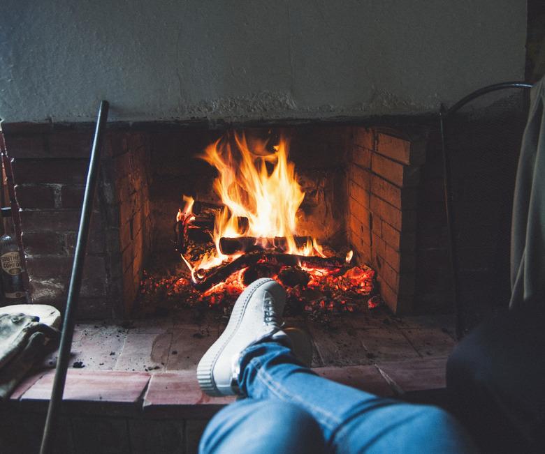 Low Section Of Person By Fireplace At Home