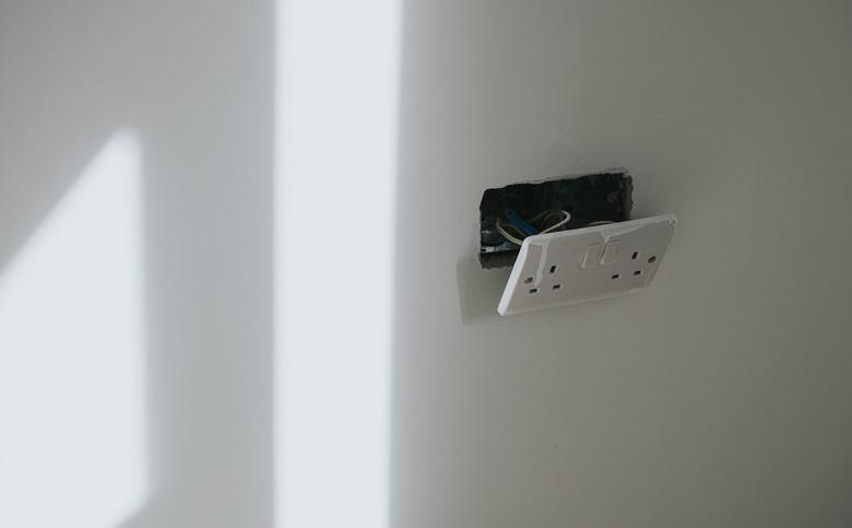 Plug Socket hanging off a freshly plastered wall in a new Build