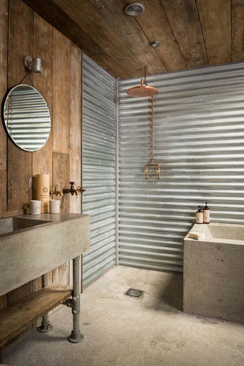 Reclaimed wood and concrete combined make this rustic bathroom utterly unique.