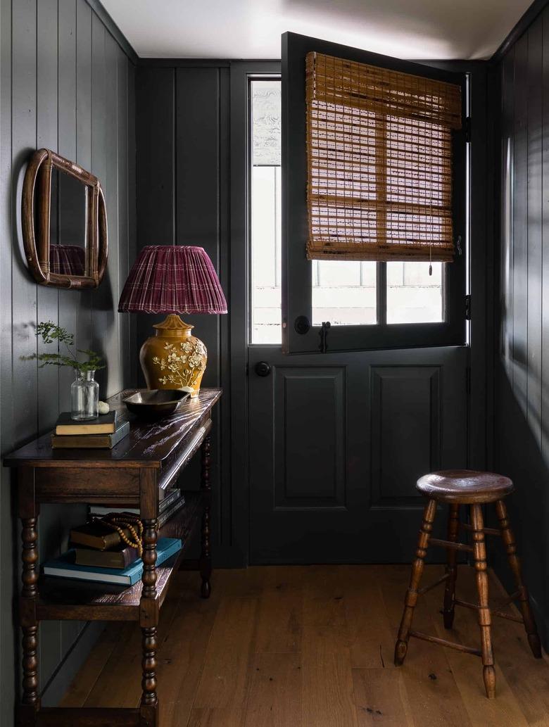 black shiplap hallway with wood floors