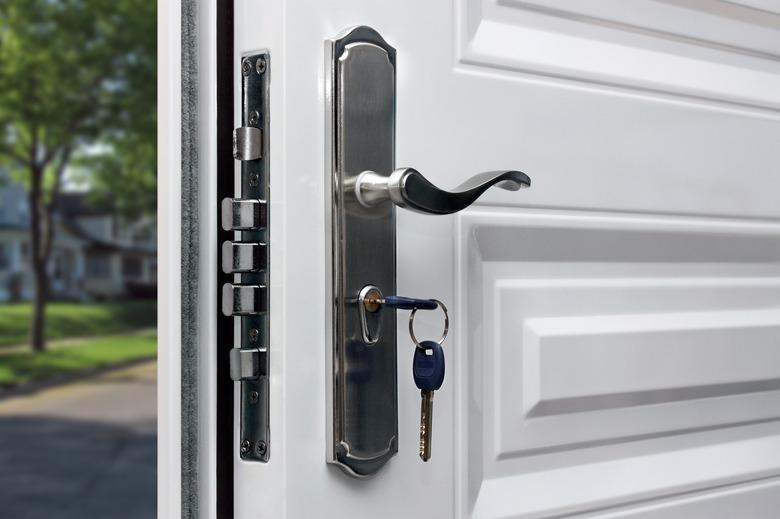 Opened door of a family home. Close-up of the lock with your keys on an armored front door. Security.