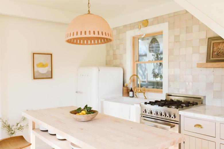 desert themed kitchen with island and tile backsplash