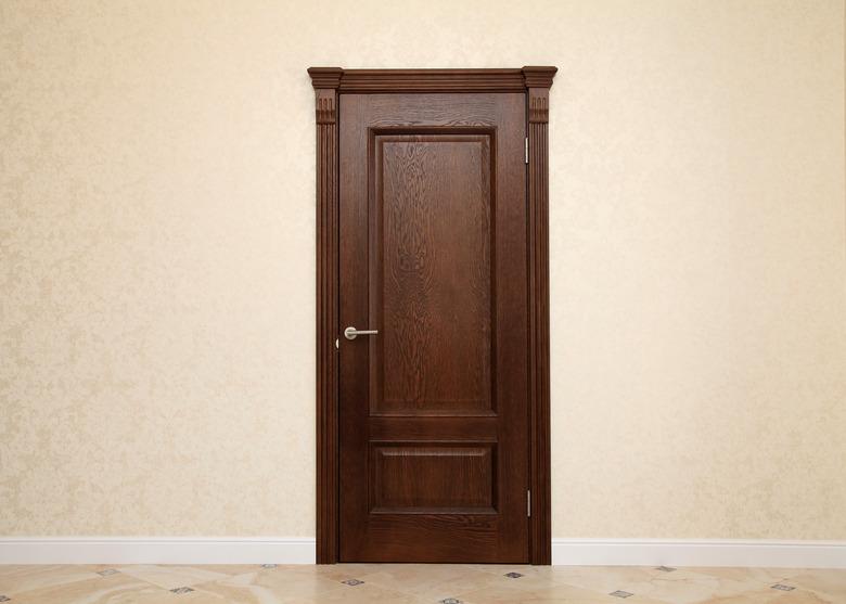 empty beige room interior with brown wooden door