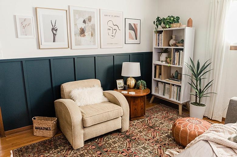 Living room with a blue board and batten wall, neutral and white furniture and decor