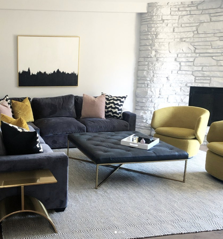 modern family room ideas with yellow swivel chairs and upholstered coffee table