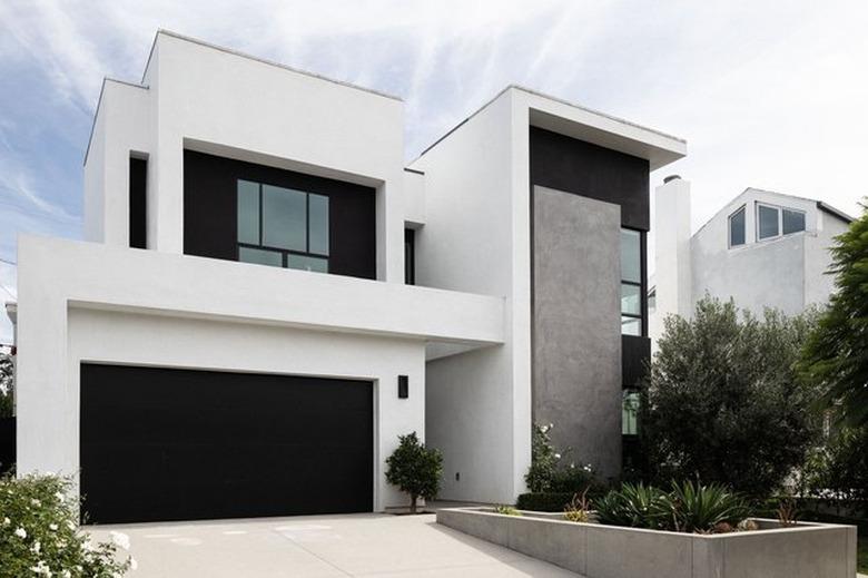 modern home with large black modern garage doors