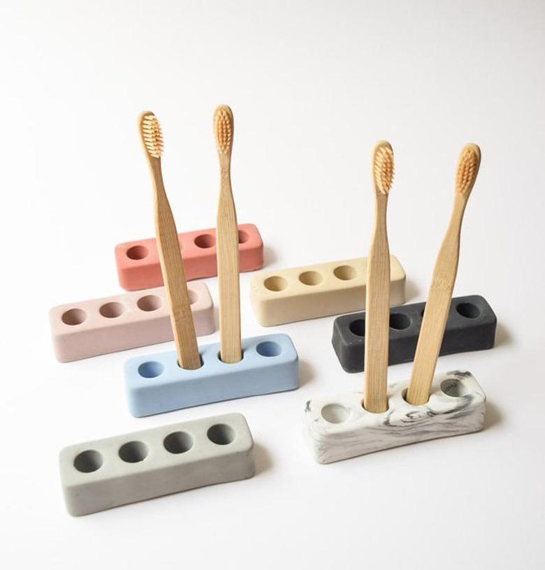 Toothbrush holders in a variety of colors with wood toothbrushes