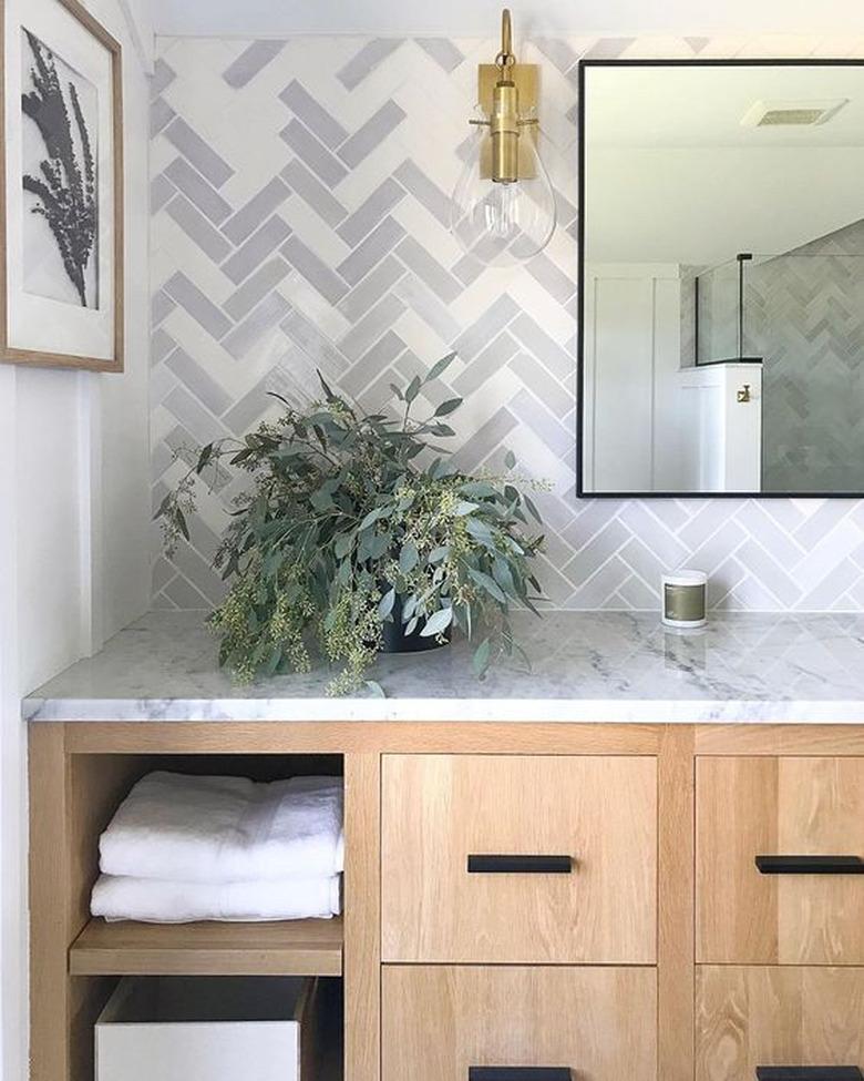 mosaic tile bathroom backsplash idea with gray and white herringbone tile