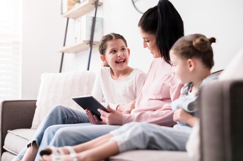 Happy family using digital tablet together