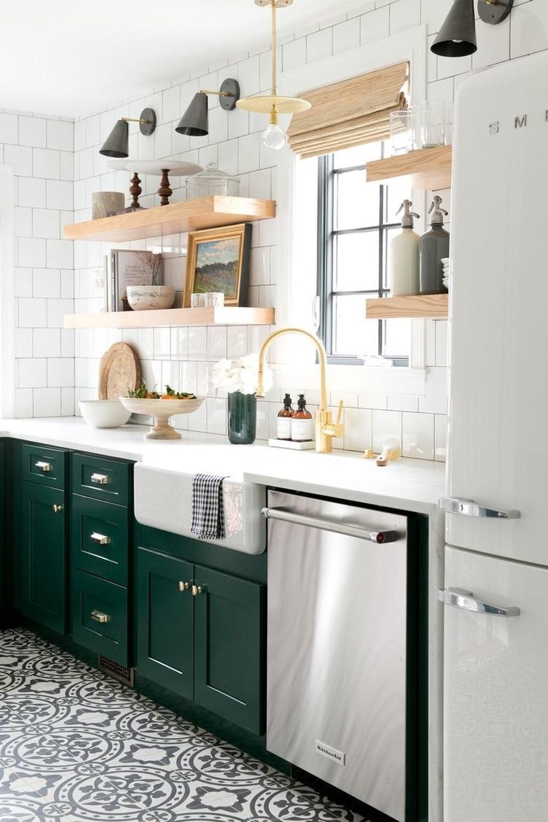 Kitchen organization ideas in space with white tile backsplash and green cabinetry