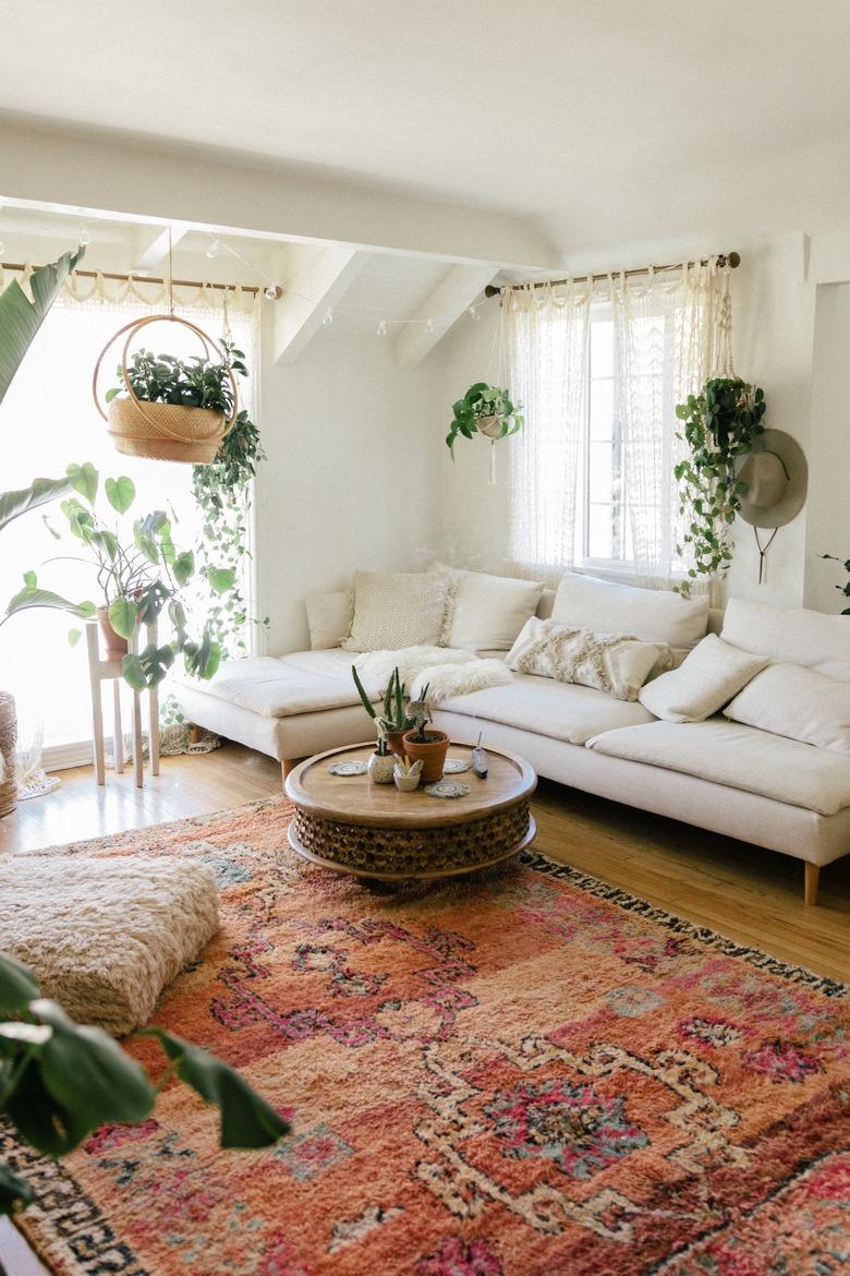 natural decor in white living room with bright red rug