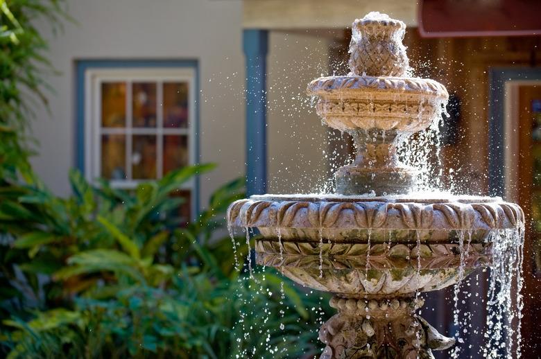 Two-tiered garden fountain flowing with water